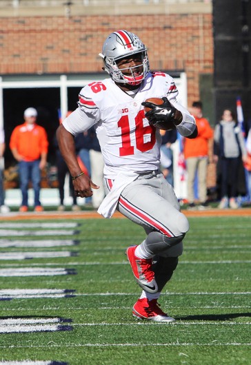 Redshirt sophomore quarterback J.T. Barrett (16) carries the ball during OSU's 28-3 win over Illinois on Nov. 14 in Champaign, Illinois. Credit: Samantha Hollingshead | Photo Editor
