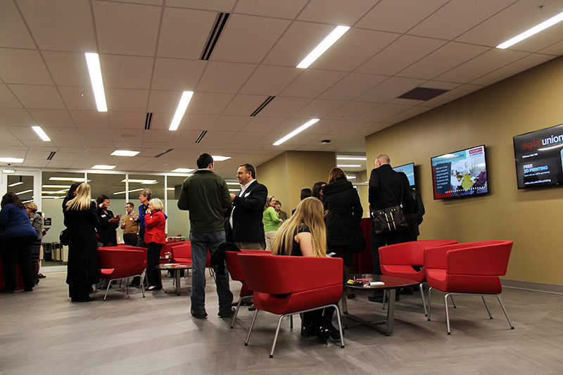 Visitors gathering in the gallery area of the Research Commons, located on the third floor of the 18th Avenue Library, during the location’s opening event on Jan. 26. Credit: Michael Huson | Campus Editor 