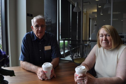 Charles and Joyce Busch sit over coffee in the lounge of Busch House residence hall, named after Charle's brother, Jon. Credit: Nick Roll | Campus Editor