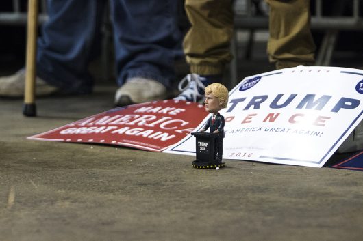 Supporters lay out Donald Trump signs and a bobblehead on the floor during a rally in Delaware, Ohio on Oct. 20. Credit: Alexa Mavrogianis | Photo Editor
