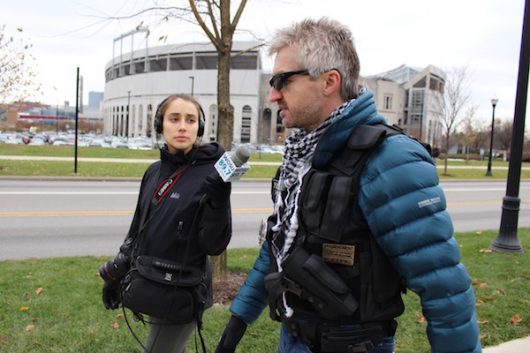 A protester speaks with a WOSU reporter while walking past The 'Shoe on Dec. 5.Credit: Nick Roll | Campus Editor